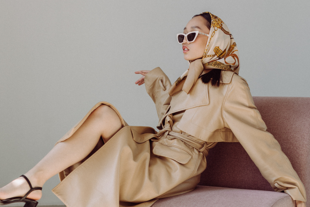 Model posing wearing a silk scarf on her head